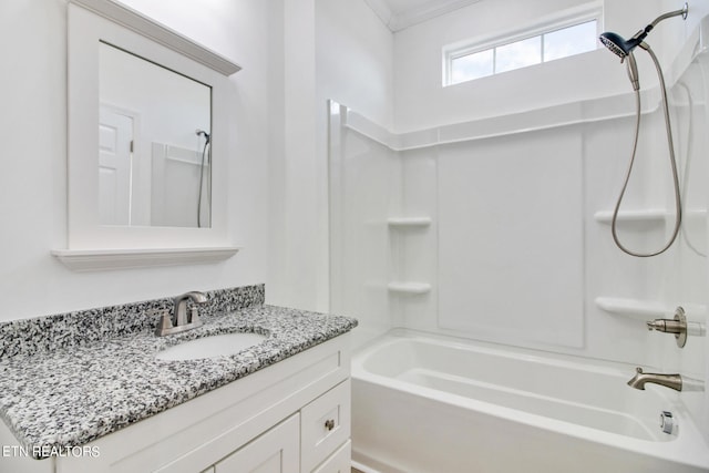 bathroom featuring vanity, washtub / shower combination, and crown molding