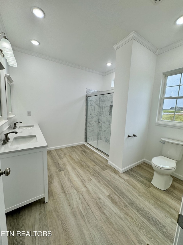 bathroom with walk in shower, crown molding, toilet, and hardwood / wood-style flooring