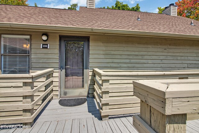 property entrance with a deck