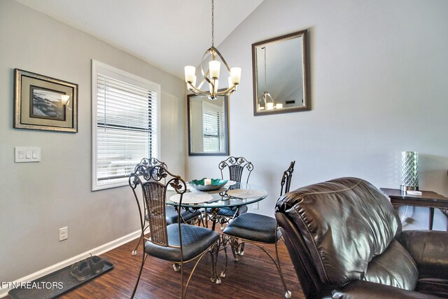 dining room featuring dark hardwood / wood-style floors, a chandelier, and vaulted ceiling