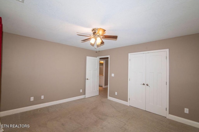 unfurnished bedroom featuring ceiling fan, a closet, carpet flooring, and baseboards