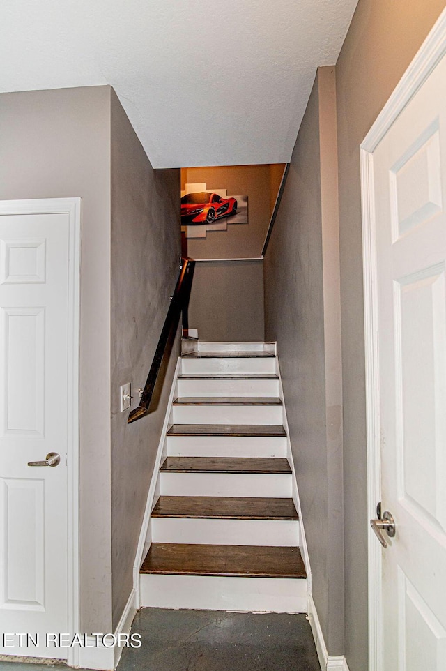 stairway with concrete floors