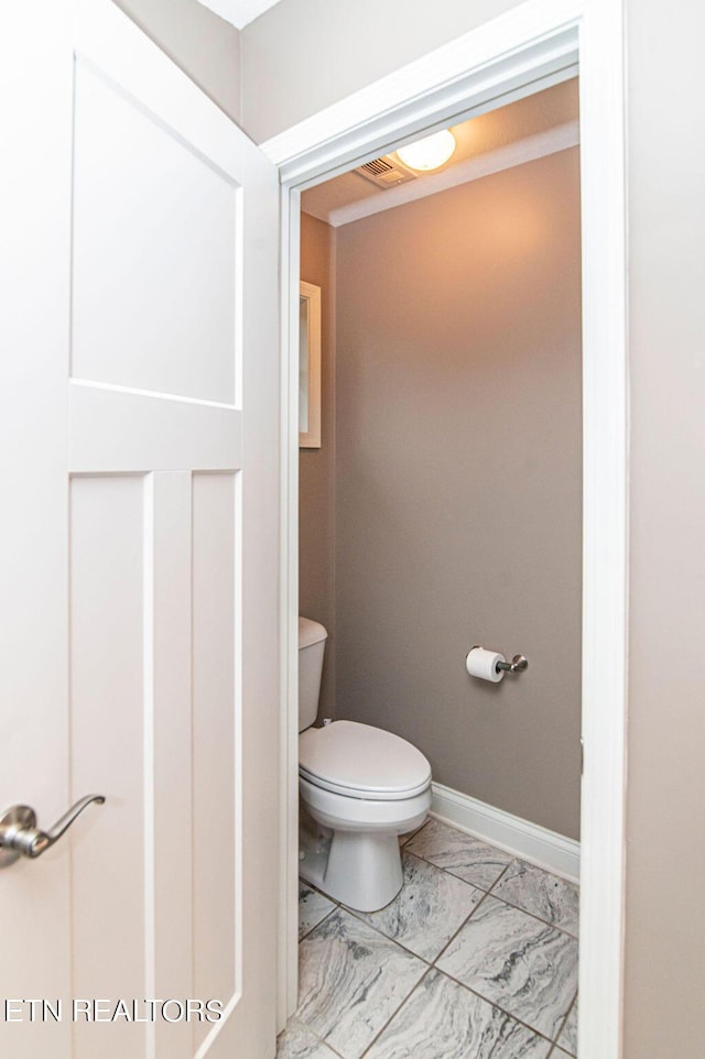 bathroom with visible vents, marble finish floor, toilet, and baseboards