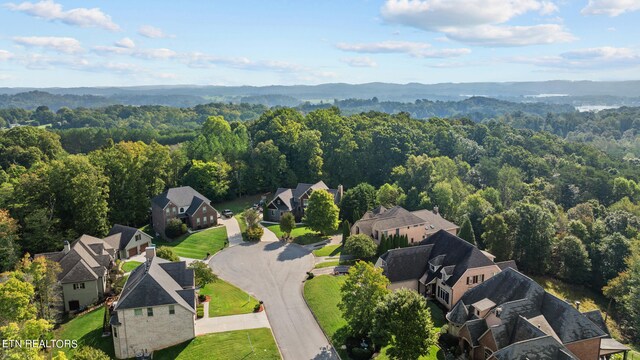 drone / aerial view with a residential view and a view of trees