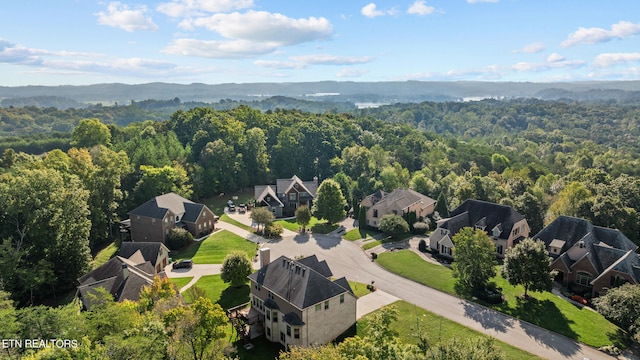 bird's eye view with a wooded view and a residential view