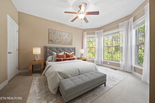 bedroom with baseboards, multiple windows, and visible vents