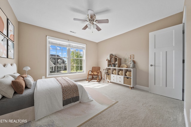 bedroom with carpet floors, a ceiling fan, visible vents, and baseboards