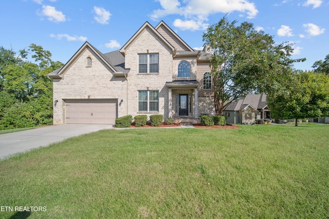 view of front of house with a front yard, brick siding, driveway, and an attached garage