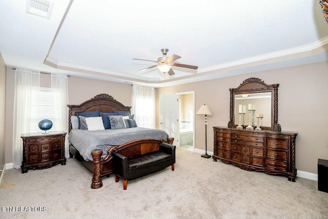 carpeted bedroom featuring visible vents, a tray ceiling, baseboards, and ornamental molding