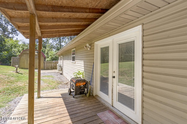 deck featuring french doors and a shed