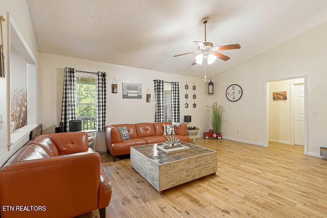 living room featuring lofted ceiling, light hardwood / wood-style flooring, and ceiling fan