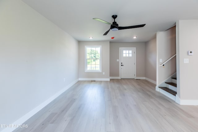 foyer with ceiling fan and light hardwood / wood-style floors