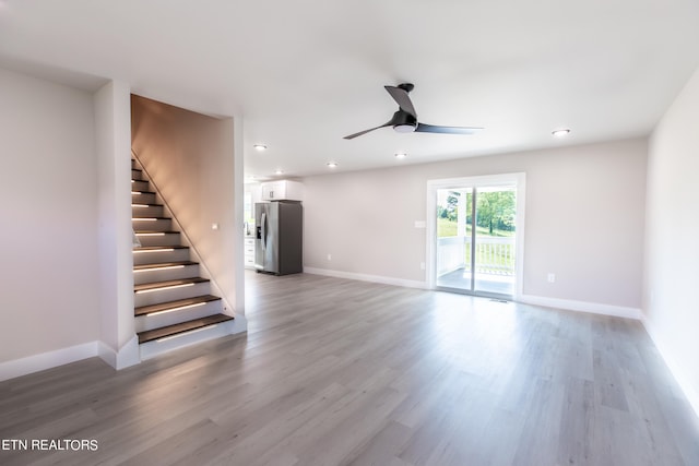 unfurnished living room with ceiling fan and light hardwood / wood-style floors