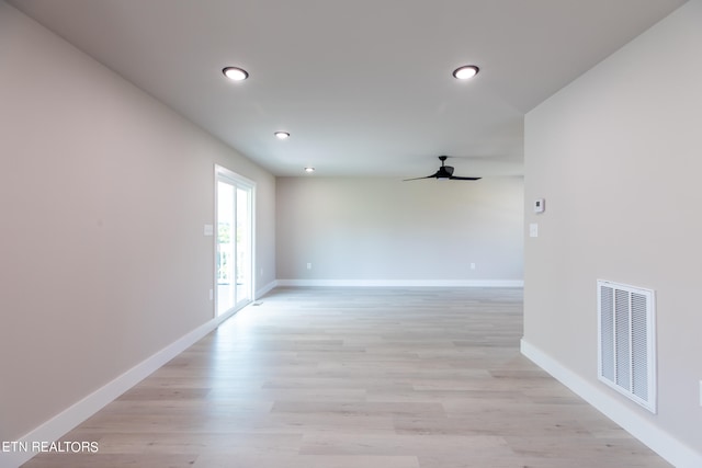 spare room featuring ceiling fan and light hardwood / wood-style floors