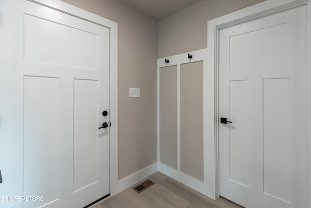 mudroom with light hardwood / wood-style flooring