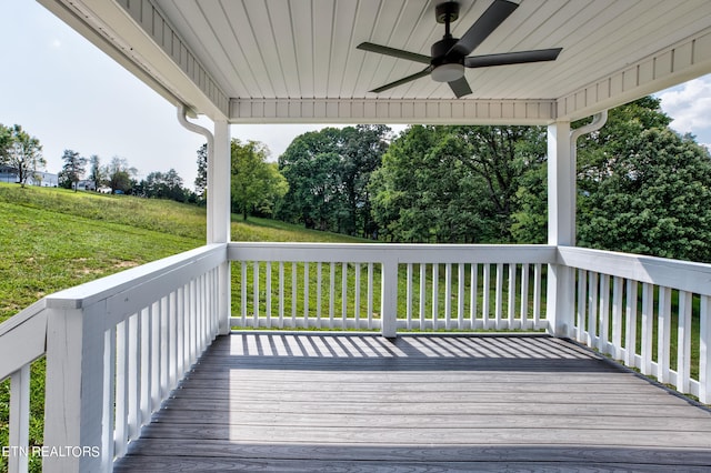 deck with ceiling fan and a lawn