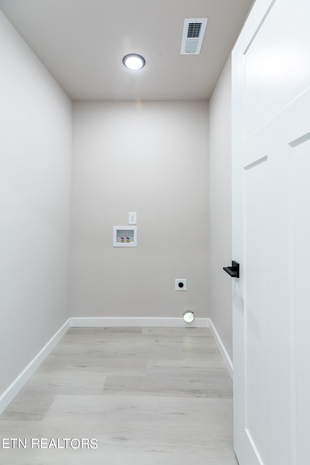 laundry room featuring hookup for an electric dryer, light hardwood / wood-style flooring, and hookup for a washing machine