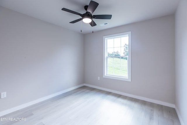 empty room with ceiling fan and light hardwood / wood-style floors