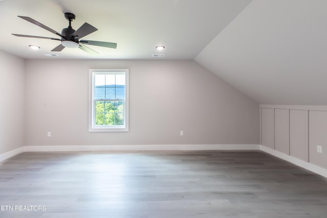 additional living space featuring ceiling fan, lofted ceiling, and hardwood / wood-style floors