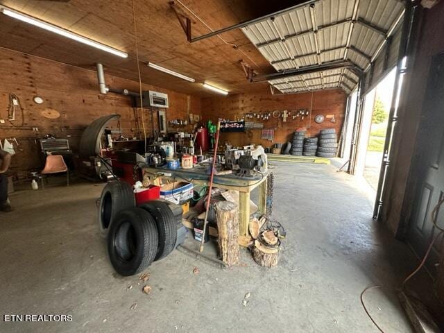 garage featuring a workshop area and a wall unit AC