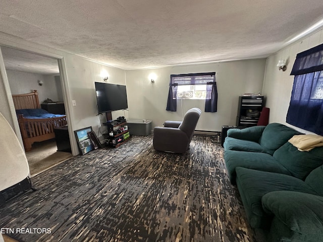 living room featuring dark hardwood / wood-style flooring, a textured ceiling, and a baseboard heating unit