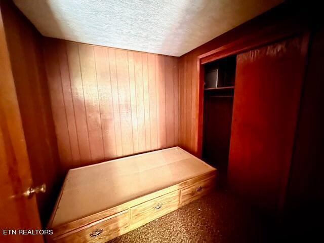 unfurnished bedroom with a closet and a textured ceiling