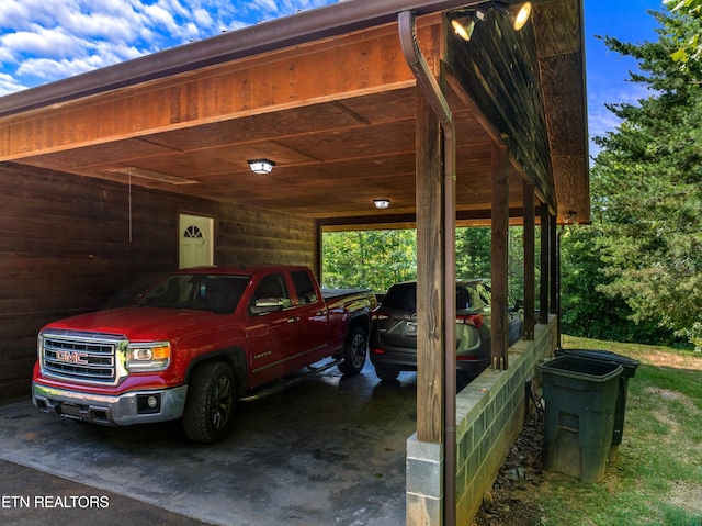 exterior space featuring wood walls and a carport