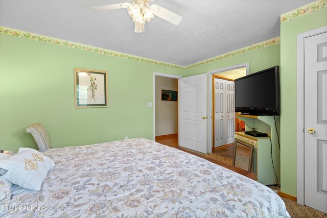 bedroom with ceiling fan and tile patterned floors