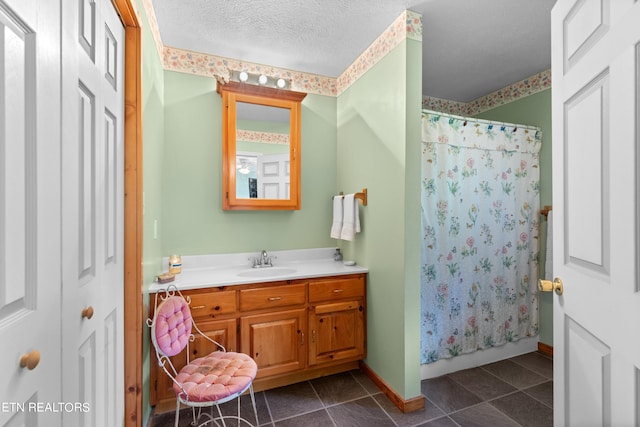 bathroom with tile patterned floors, a shower with shower curtain, a textured ceiling, and vanity