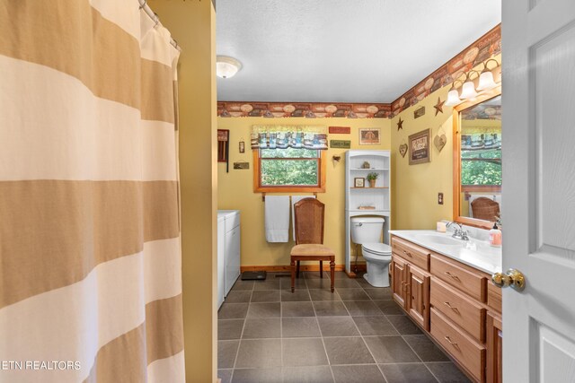 bathroom with vanity, toilet, and tile patterned flooring