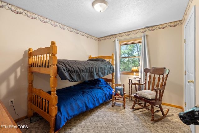 bedroom featuring carpet and a textured ceiling