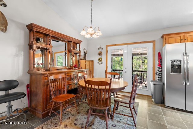 tiled dining space with lofted ceiling, an inviting chandelier, and french doors