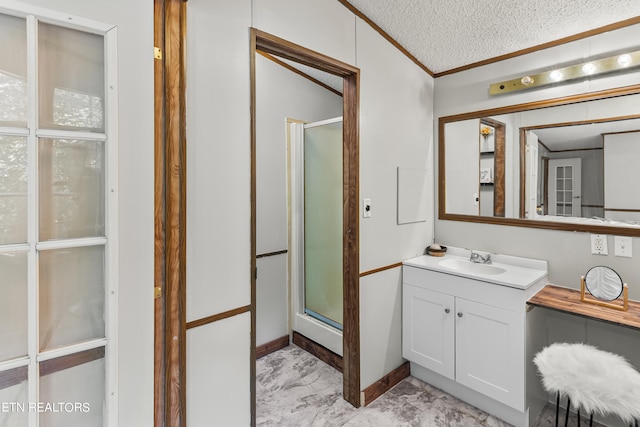 bathroom with vanity, a textured ceiling, and walk in shower