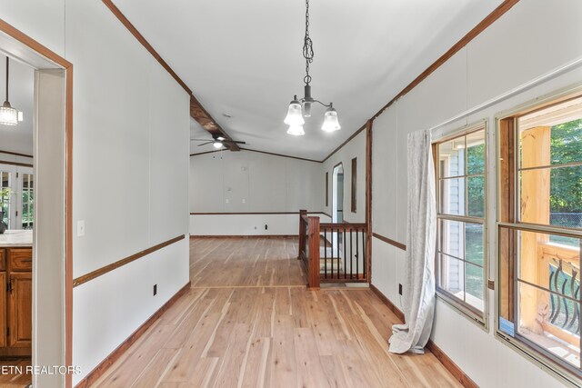 interior space featuring light wood-type flooring, an inviting chandelier, and a wealth of natural light