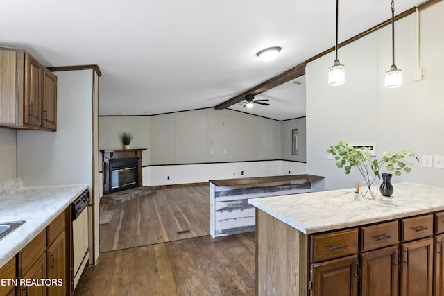 kitchen with hanging light fixtures, dark hardwood / wood-style floors, ceiling fan, dishwashing machine, and a kitchen island