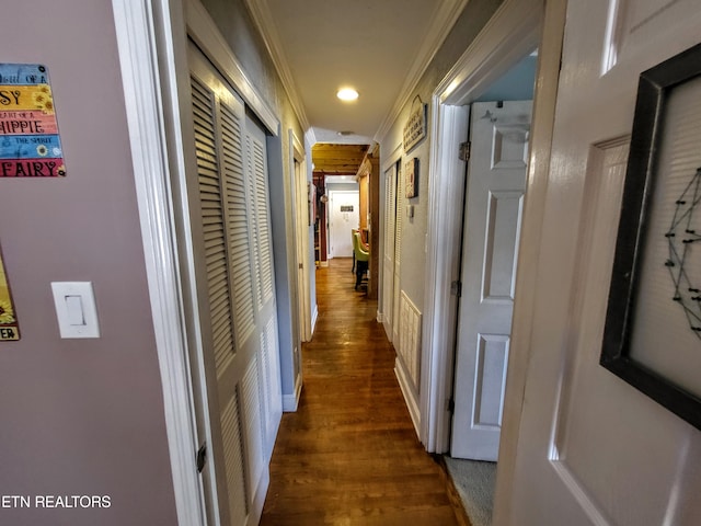 hall with dark hardwood / wood-style floors and ornamental molding