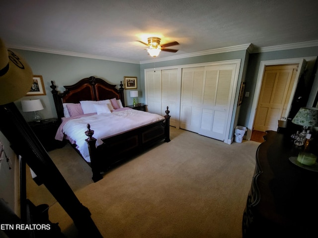 bedroom with multiple closets, crown molding, light colored carpet, and ceiling fan