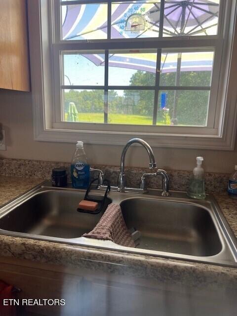 room details with dark stone countertops and sink