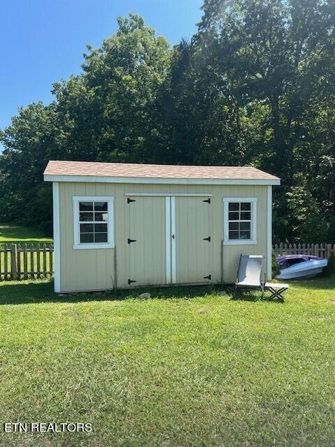 view of outbuilding with a yard