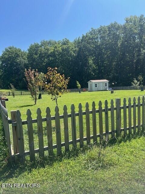 view of yard featuring a storage shed and a rural view