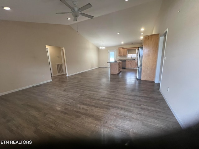 unfurnished living room featuring sink, ceiling fan, vaulted ceiling, and dark hardwood / wood-style floors