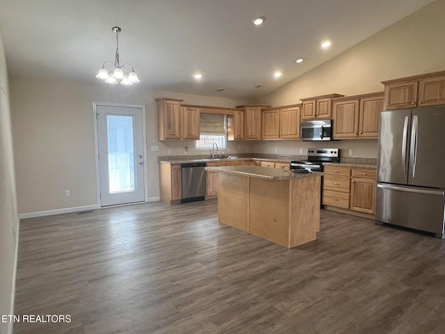 kitchen with hanging light fixtures, a kitchen island, dark hardwood / wood-style floors, sink, and stainless steel appliances