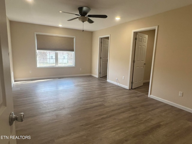 unfurnished bedroom with dark wood-type flooring and ceiling fan