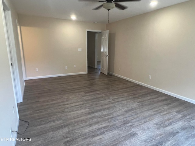 unfurnished room with ceiling fan and dark hardwood / wood-style flooring