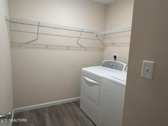 laundry area with dark wood-type flooring and separate washer and dryer