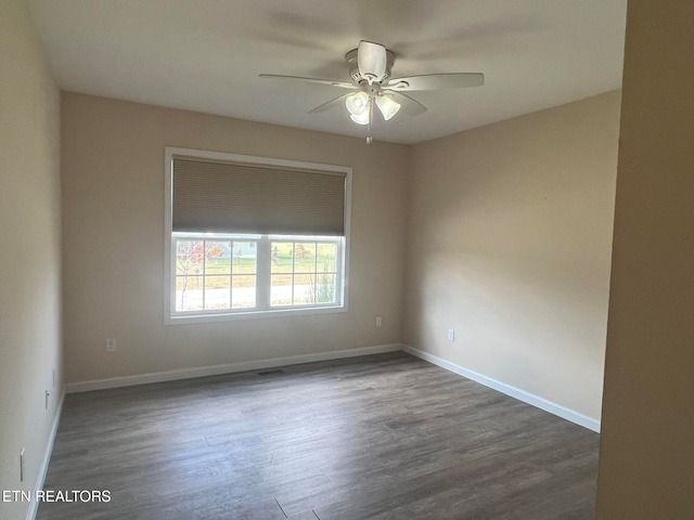 empty room featuring ceiling fan and dark hardwood / wood-style flooring