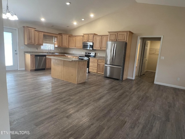 kitchen with appliances with stainless steel finishes, a center island, pendant lighting, high vaulted ceiling, and dark hardwood / wood-style floors