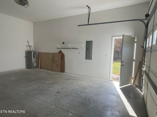 garage featuring electric panel, water heater, and a garage door opener