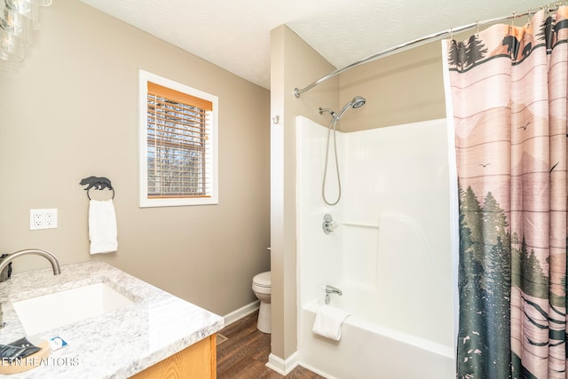 full bathroom with toilet, vanity, hardwood / wood-style flooring, a textured ceiling, and shower / bathtub combination with curtain