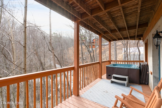 wooden deck with a hot tub